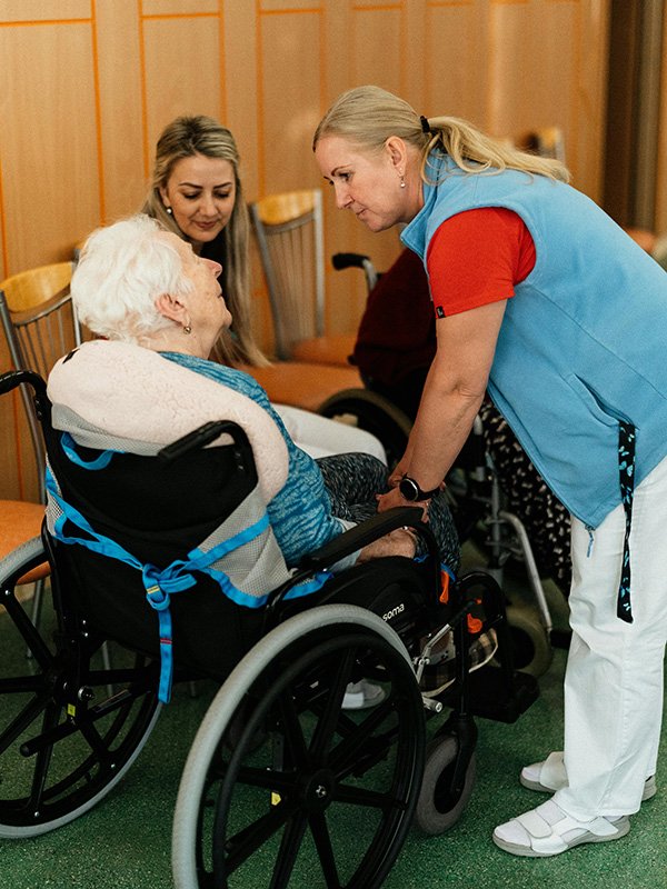 Caregiver interacting with Elderly Lady in a wheelchair