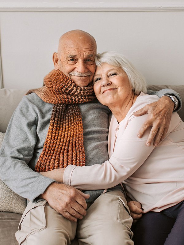 Elderly Couple sitting on couch